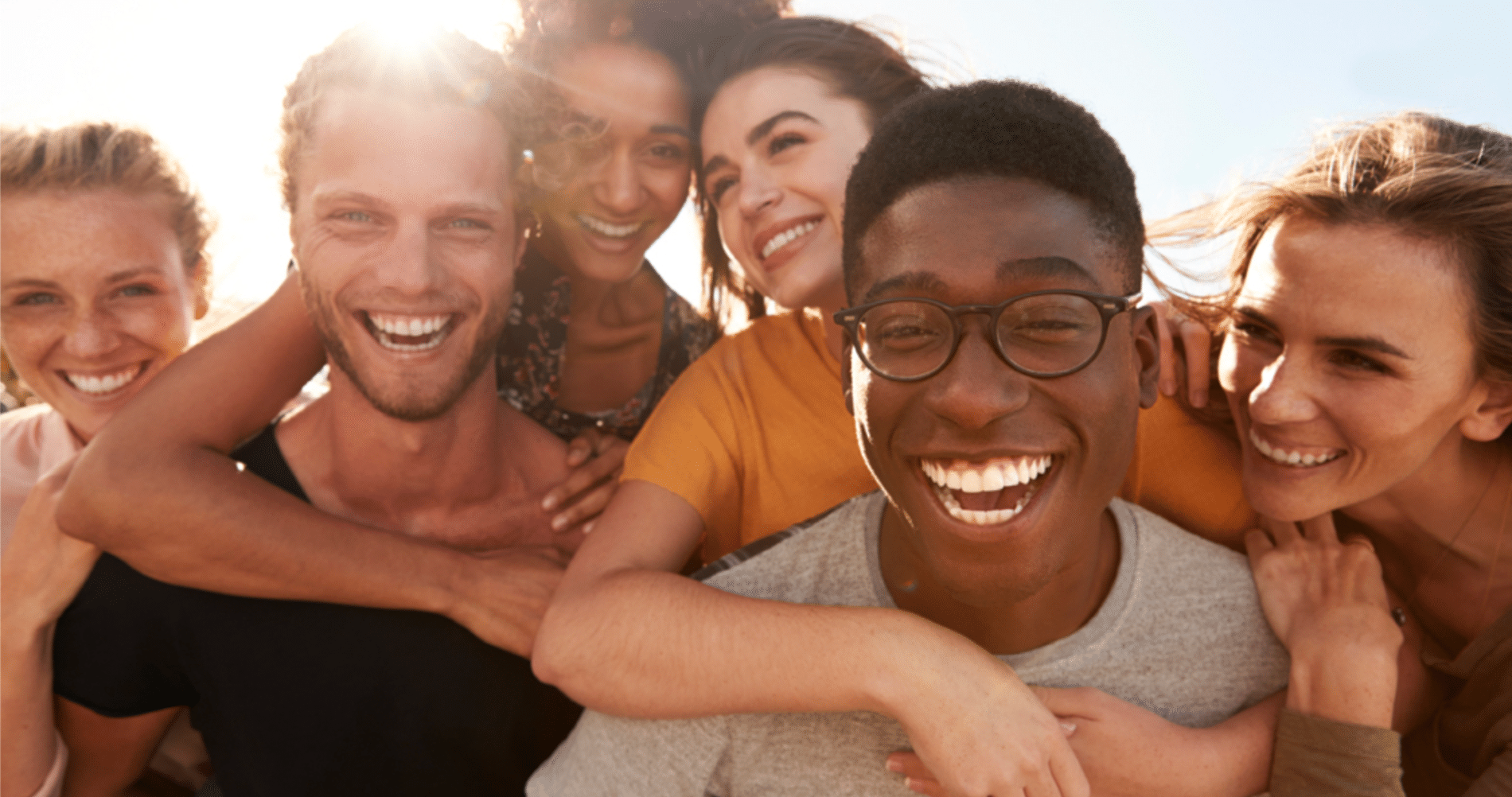 group of friends laughing in the sunlight